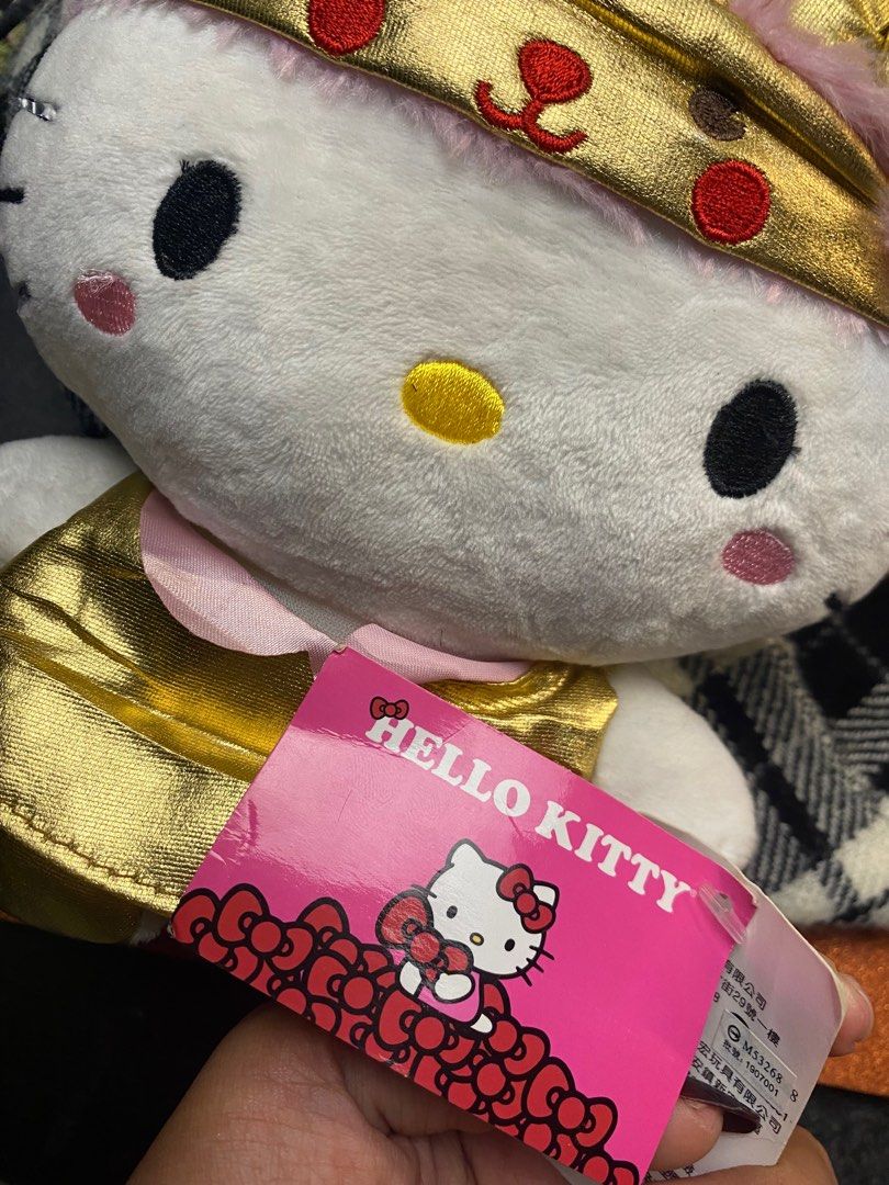 Hello Kitty Lunar New Year Plush Toy (Category: Plushies & Soft Toys) located in Zamboanga. Submitted by timeless_chi (Listing ID 1415402522, Image 3). Description: - Kitty plush toy - Dressed in a Lunar New Year outfit - Gold dress and headpiece with pink accents - Official Kitty tag attached - Licensed Sanrio product.