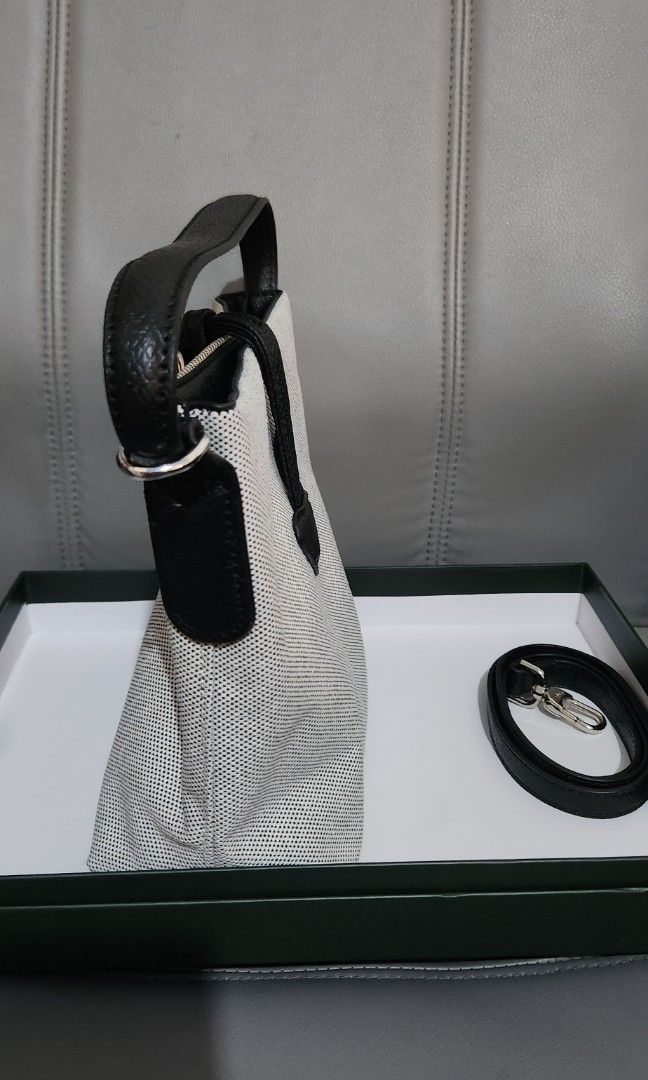 Longchamp Le Pliage Cuir Handbag (Category: Luxury Bags & Wallets) located in Mabini. Submitted by wearandcarry (Listing ID 1415298850, Image 3). Description: - Longchamp mesh handbag - Top handle and detachable shoulder strap - Black leather trim - Silver-tone clasp - Longchamp logo on the front - Bucket style design.