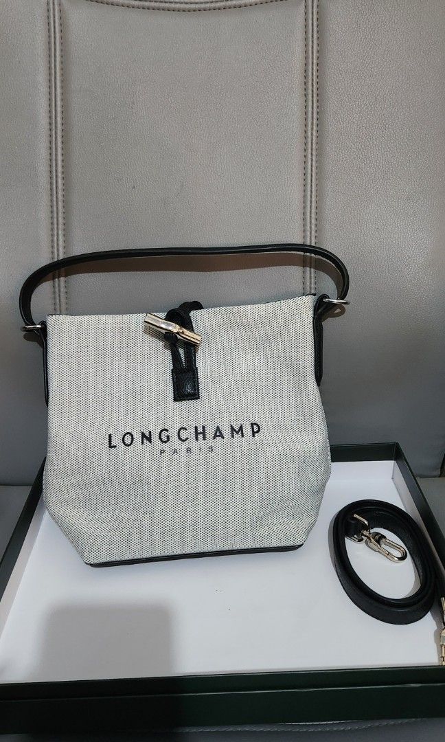 Longchamp Le Pliage Cuir Handbag (Category: Luxury Bags & Wallets) located in Mabini. Submitted by wearandcarry (Listing ID 1415298850, Image 2). Description: - Longchamp mesh handbag - Top handle and detachable shoulder strap - Black leather trim - Silver-tone clasp - Longchamp logo on the front - Bucket style design.