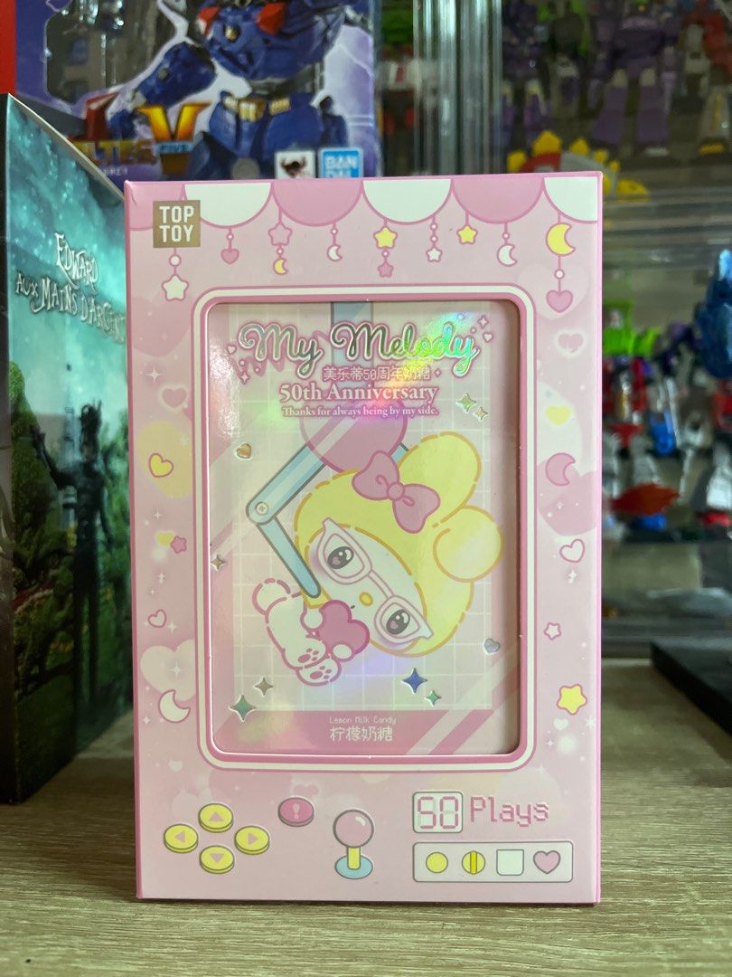 Milk Candy My Melody 50th Anniversary Keychain (Category: Character Goods) located in Bacoor. Submitted by illbimbo (Listing ID 1415280952, Image 2). Description: - My Melody 50th Anniversary Keychain - Features a cute My Melody design - Includes a heart-shaped charm - Comes in a pink, game-themed blind box - Blind box item: 1/6 chance of this design - Box indicates 50 plays.