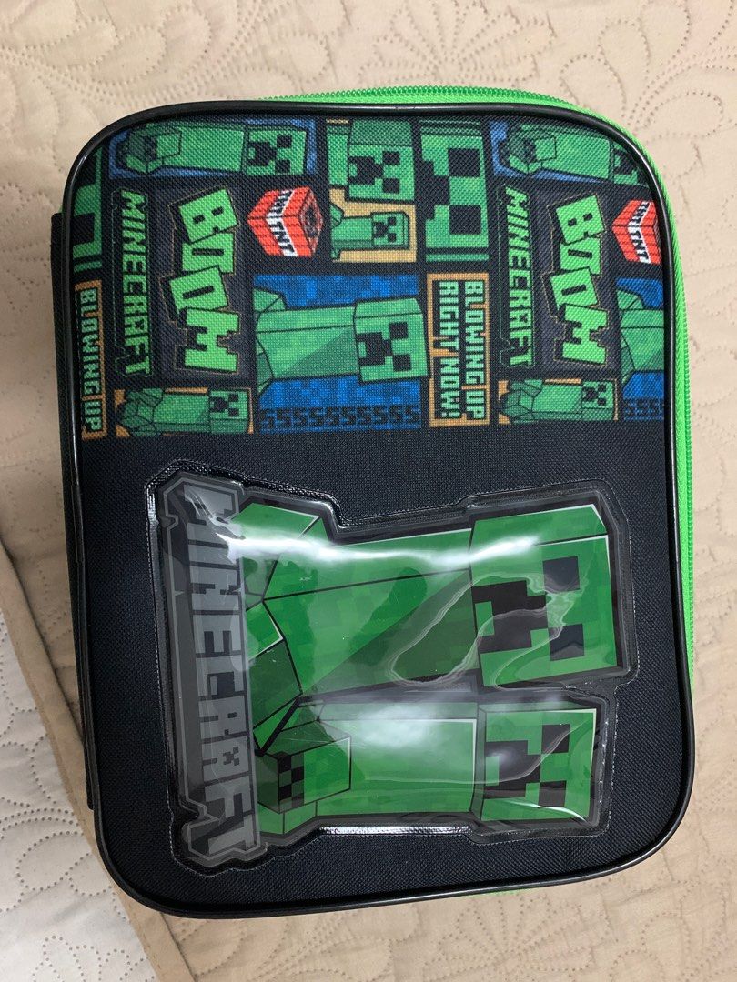 Minecraft Lunch Bag by Bioworld (Category: Babies & Kids Fashion) located in Caloocan City. Submitted by 0496junque (Listing ID 1415379912, Image 1). Description: - Minecraft Creeper lunch bag - Brand: Bioworld - Features the iconic Creeper design - Includes the Minecraft logo - Black base with a green zipper - Insulated interior - Made in China.