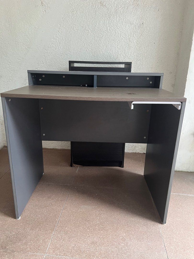 Study table / computer table (Category: Desktops) located in Manila. Submitted by raymiii (Listing ID 1415359756, Image 3). Description: grey and dark wood-finish particle board office or computer desk with an elevated monitor stand and a small under-desk storage unit. Still nego.