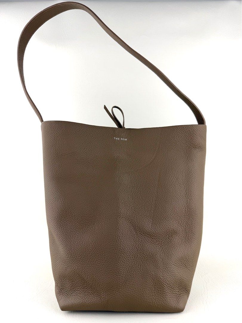 THE ROW N/S Park Medium Tote Bag (Category: Luxury Bags & Wallets) located in Manila. Submitted by luvluxe.mnl (Listing ID 1415262213, Image 1). Description: Medium size- can fit a lot So chic& elegant!!! In taupe color SRP is 95k+ on online websites.