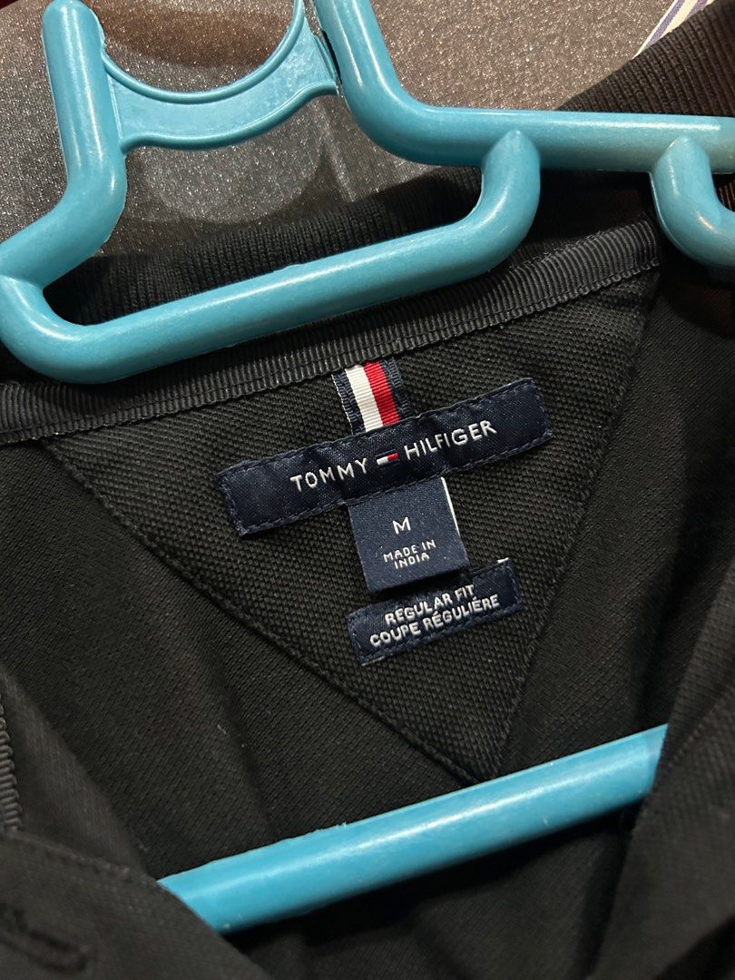 Tommy Hilfiger Black Polo Shirt - Medium (Category: Shirts) located in Manila. Submitted by lrocamora (Listing ID 1415401656, Image 1). Description: - Tommy Hilfiger black polo shirt - Size: Medium - Features the iconic Tommy Hilfiger logo - Regular fit - Classic design - Short sleeves - Three-button placket - Collar with Tommy Hilfiger stripe detail.