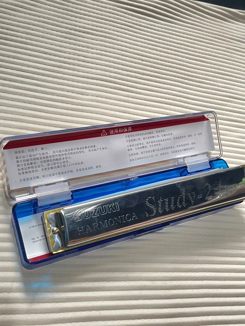 uzuki Study-24 24-hole tremolo harmonica in its clear plastic case (Category: Musical Instruments) located in Santa Rita. Submitted by malaguco. (Listing ID 1415389586, Image 3). Description: Type and Holes: It is a tremolo harmonica with 24 holes. Key: The model typically comes in the key of C, though other keys like A are also available. Construction: Features a compact and durable stainless steel cover plate with high glossiness. Adopts eco-fr