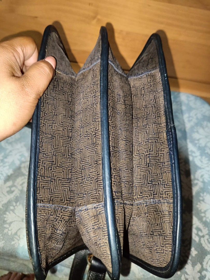 Vintage Lanvin Shoulder Bag (Category: Luxury Bags & Wallets) located in Baguio. Submitted by iyaberong48242 (Listing ID 1415256310, Image 3). Description: - Authentic Lanvin Sling bag - Brown patterned exterior - Black strap and accents - Gold-tone clasp - Flap closure - Made in Italy - Genuine leather - Interior: Multiple compartments and zippered pocket - Lanvin logo inside.