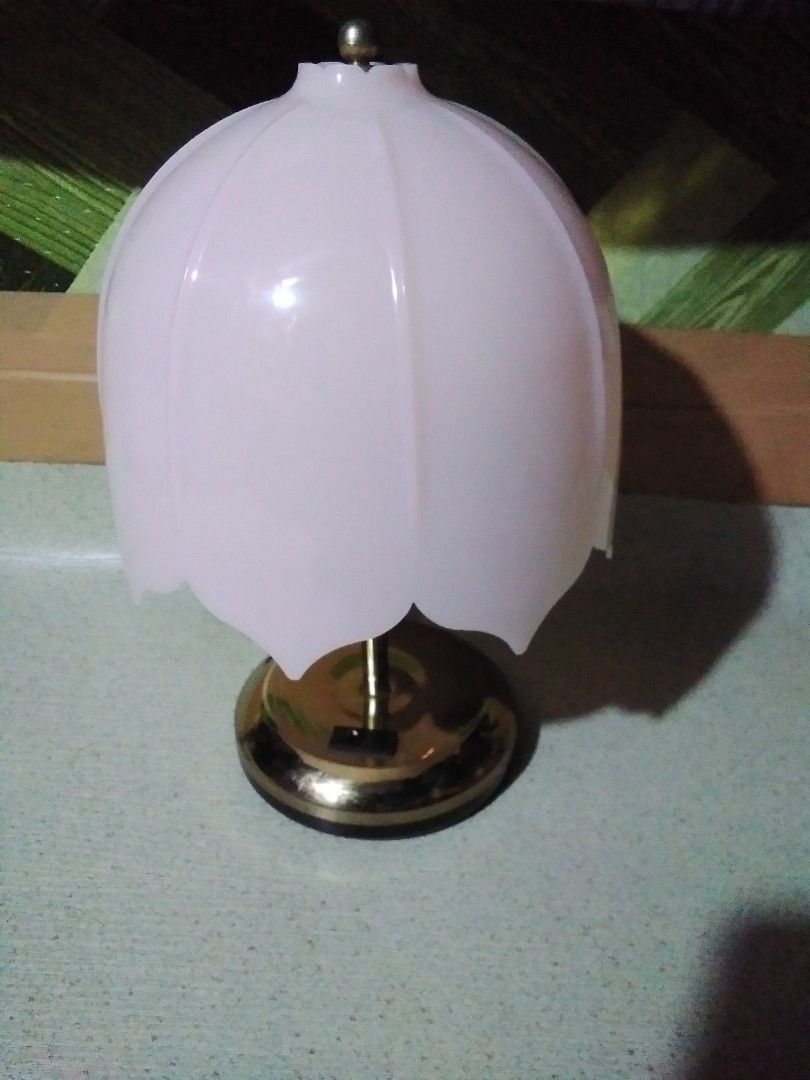 Vintage Tulip Wall Lamp (Category: Lighting) located in Quezon City. Submitted by Bernz (Listing ID 1415388430, Image 1). Description: - Vintage tulip wall lamp -Karen Peacock flower shaped table lamp. - Gold-colored base - White or light pink shade - Includes power cord - Provides soft, ambient lighting - Classic design suitable for various interior styles.