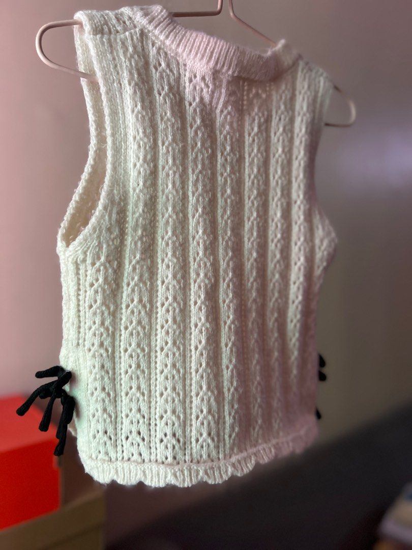 White Knit Vest with Black Ties (Category: Babies & Kids Fashion) located in Angeles City. Submitted by lovedbyava (Listing ID 1415265748, Image 2). Description: - White knit vest - V-neck design - Intricate knit detailing - Black side ties - Sleeveless - Lightweight material - Versatile for layering.