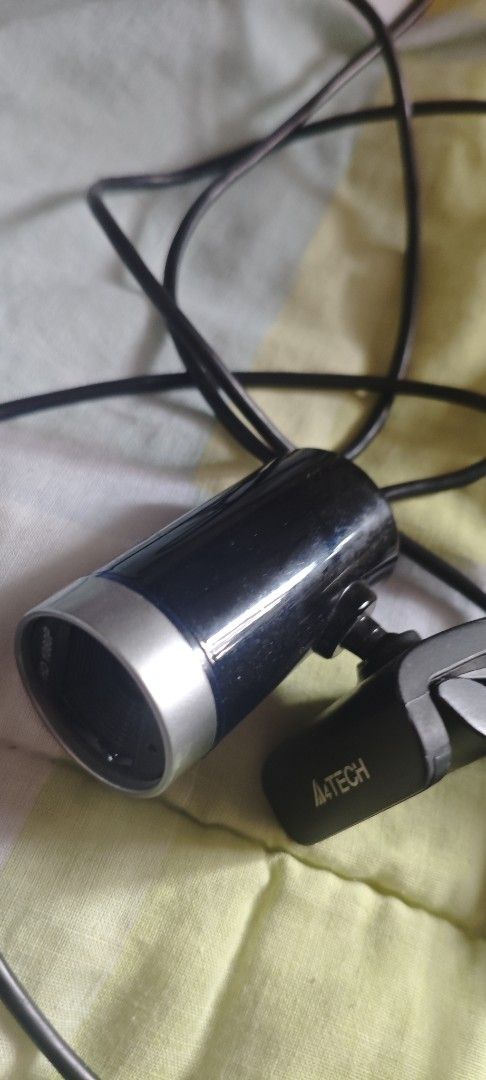 A4TECH HD 1080P webcam (Category: Webcams) located in Manila. Submitted by sakakibaraakiharu (Listing ID 1415557697, Image 2). Description: A4TECH dash cam with HD 1080P resolution. Features a black cylindrical body with a silver trim. Includes a microphone and a cable. The model name is visible on the device. The item has a JCSM sticker. No issues with operation, I'm just upgrading. Been using it for over two or three years. Location: Corner of 