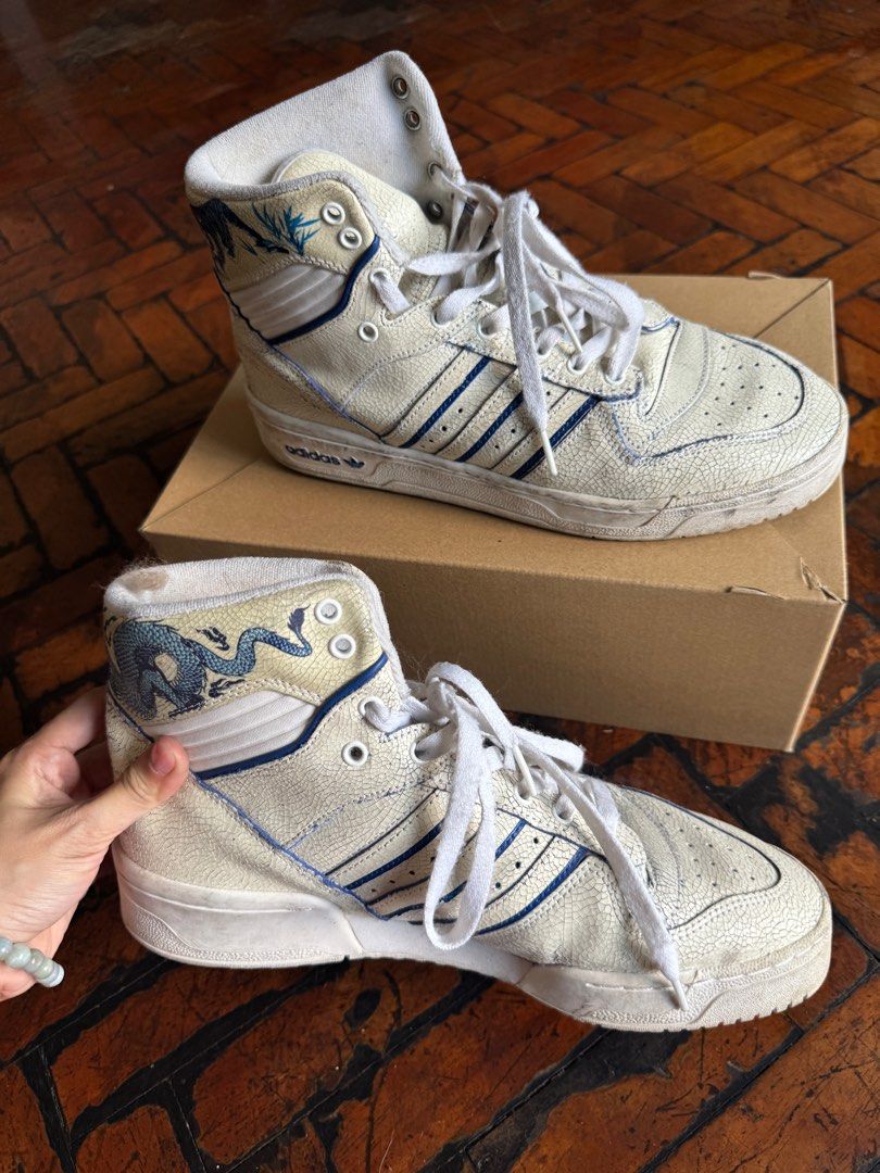 Adidas Rivalry White Blue (Porcelain design) (Category: Sneakers) located in Manila. Submitted by classy.home (Listing ID 1415474831, Image 3). Description: 2. Adidas Rivalry White Blue (Porcelain design) Condition: Slightly used (7.8/10) Size: US 9.5 Sale Price: 2200 *** Please note that is its the design of Porcelain effect and not tear down leather.
