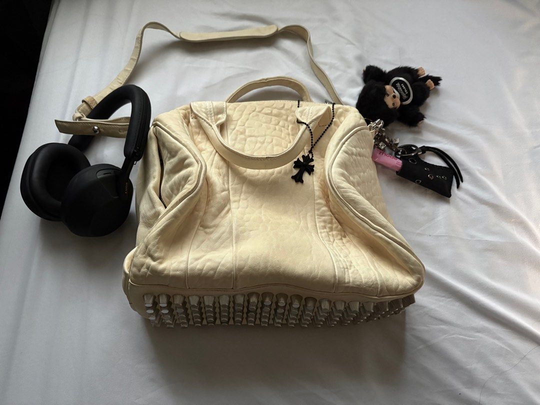 (SOLD) Alexander Wang Rocco Duffel Bag Vanilla (Category: Luxury Bags & Wallets) located in Marikina City. Submitted by gisellesniche (Listing ID 1415575049, Image 1). Description: - Authentic - 5,000 last price - Like new! no flaws. Complete rivets at the bottom & no discoloration on the leather yet - Authentic, dm for more details - Includes adjustable strap which can also be worn as a crossbody.