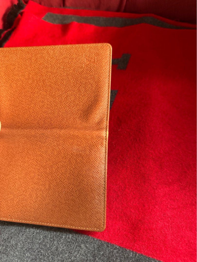 Authentic Louis Vuitton Card Holder (Category: Luxury Bags & Wallets) located in Pasig City. Submitted by pau01_ (Listing ID 1415497374, Image 3). Description: - Authentic Louis Vuitton passport holder - Color: Brown - Features a textured exterior - Iconic LV logo visible - Rectangular shape - Crafted from leather.