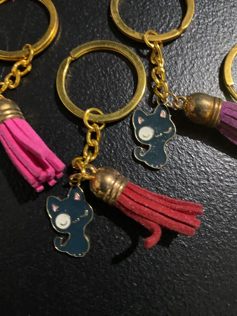 Cat Keychains with Tassels (Category: Charms) located in Valenzuela. Submitted by emg.everythingmustgo (Listing ID 1415557063, Image 3). Description: 70 each - Adorable cat keychains - Gold-colored hardware - Colorful tassels (pink, red, purple, beige) - Adds personality to keys or bags - Perfect for cat lovers!.