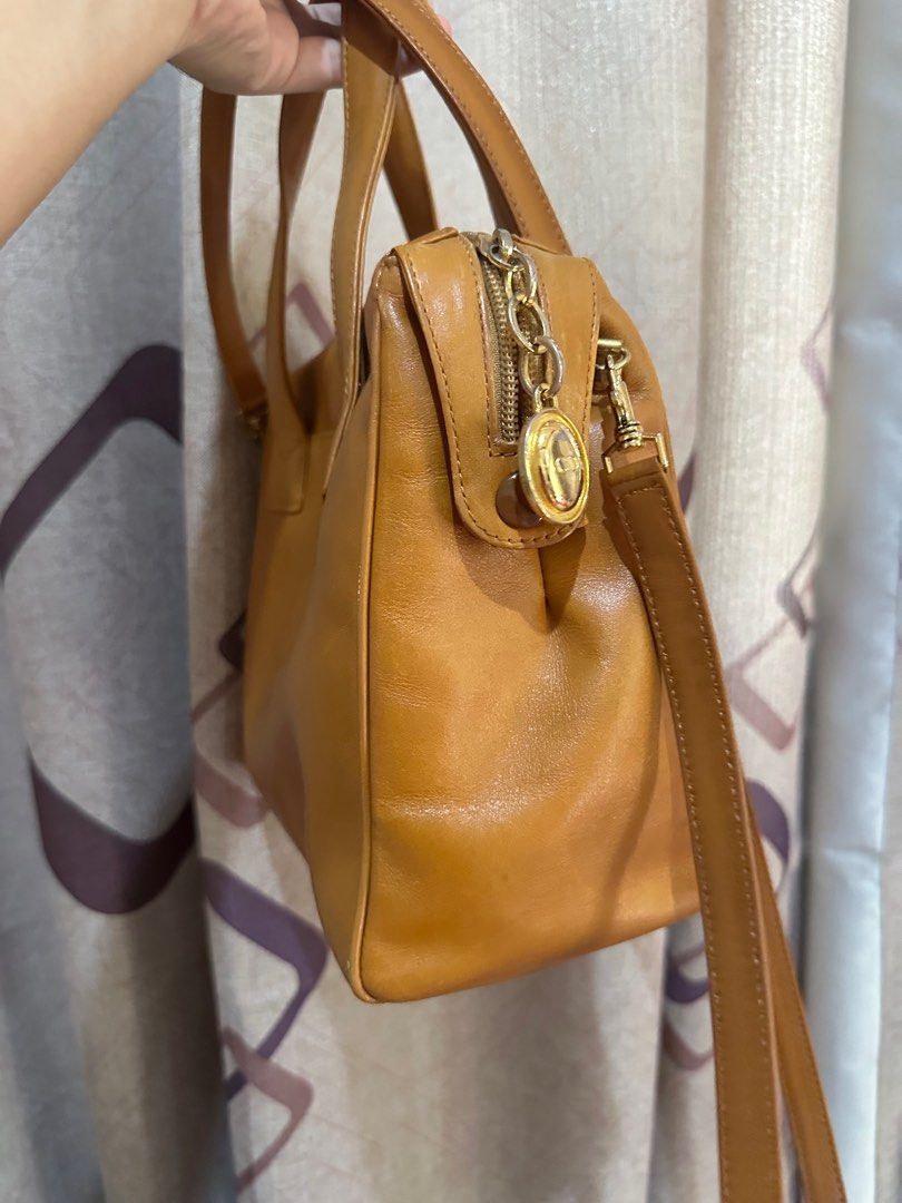 Christian Dior Brown Leather Handbag (Category: Luxury Bags & Wallets) located in Manila. Submitted by mysweetcorner (Listing ID 1415523146, Image 2). Description: - Original Christian Dior handbag - Brown leather exterior - Top handle and detachable shoulder strap - Gold-tone zipper - Includes brand logo charm - very good condition Price negotiable but NO lowballing. .