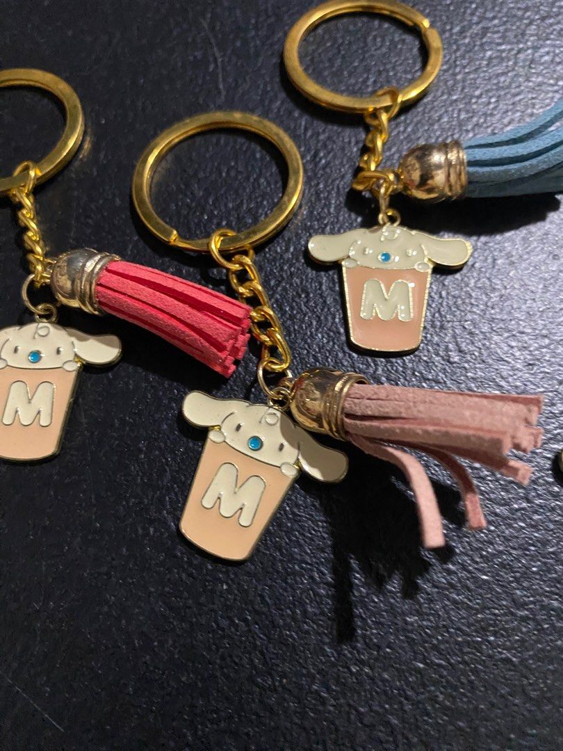 Cinnamoroll Keychain with Tassel (Category: Character Goods) located in Valenzuela. Submitted by emg.everythingmustgo (Listing ID 1415555318, Image 3). Description: 100 each - Adorable Cinnamoroll keychain. - Features a cute design with the letter 'M' on a cup. - Comes with a matching tassel (various colors). - Great for keys, bags, or accessories. - Ideal gift for Cinnamoroll fans!.