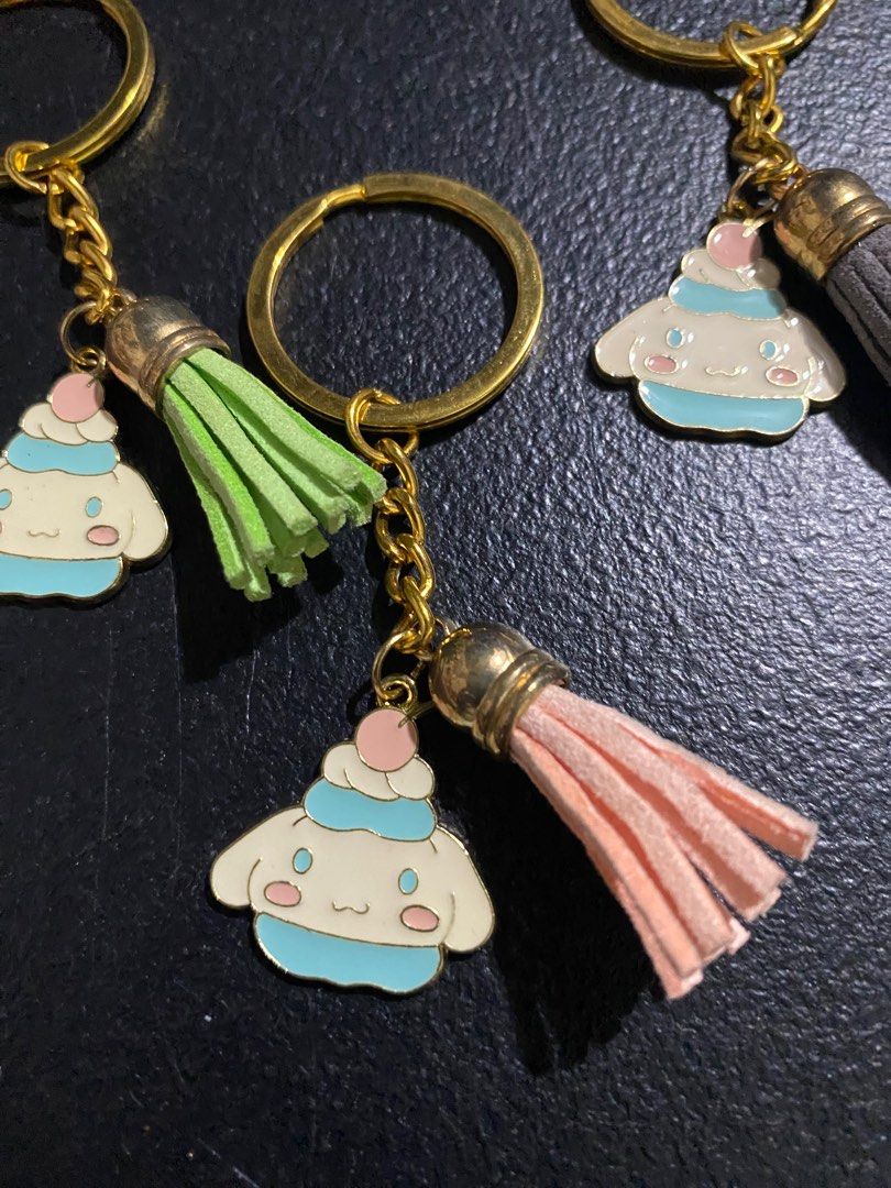 Cinnamoroll Keychains with Tassels (Category: Character Goods) located in Valenzuela. Submitted by emg.everythingmustgo (Listing ID 1415557564, Image 3). Description: 100 each - Adorable Cinnamoroll keychain - Cute character design - Colorful tassels available in: - Green - Pink - Gray - Red - Blue - Gold-colored chain and ring - Perfect for keys, bags, and accessories.