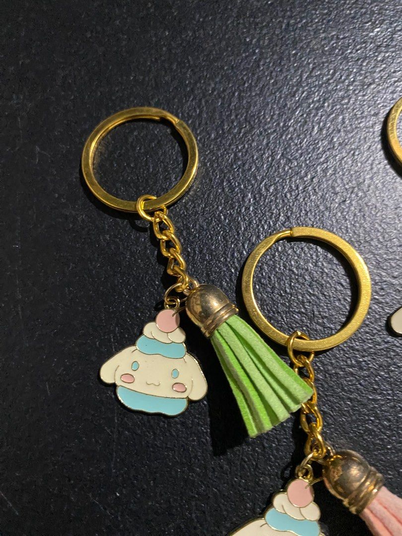 Cinnamoroll Keychains with Tassels (Category: Character Goods) located in Valenzuela. Submitted by emg.everythingmustgo (Listing ID 1415557564, Image 2). Description: 100 each - Adorable Cinnamoroll keychain - Cute character design - Colorful tassels available in: - Green - Pink - Gray - Red - Blue - Gold-colored chain and ring - Perfect for keys, bags, and accessories.