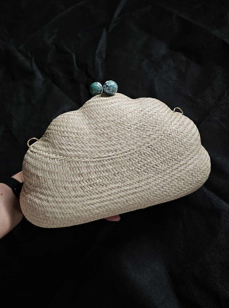 Shell-Shaped Woven Clutch with Turquoise Detail (Category: Clutches) located in Quezon City. Submitted by ilovenystuff (Listing ID 1415477992, Image 2). Description: - shell-shaped clutch bag -Buntal Woven texture - Light beige color / natural - Turquoise embellishments on clasp - Gold-colored loops for strap attachment - Suitable for various occasions - gold chain.