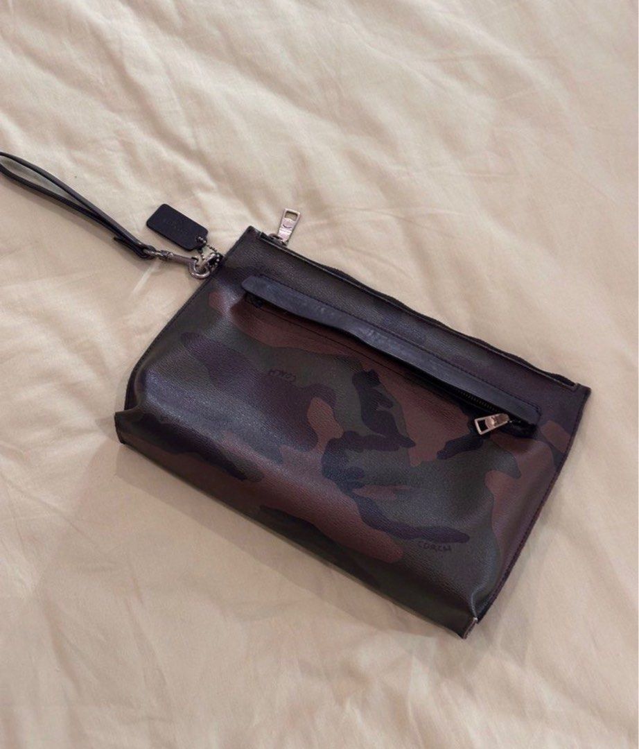 Coach Camo Clutch (Category: Luxury Bags & Wallets) located in Imus. Submitted by supercalifragilisticexpealidog (Listing ID 1415525024, Image 1). Description: - Coach camo clutch - Wrist strap included - Secure zipper closure - Interior small pocket - Features Coach logo - Stylish accessory for essentials.
