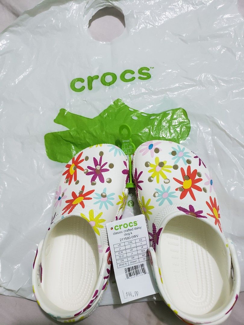 Crocs Classic Crafted Daisy Clogs (Category: Babies & Kids Fashion) located in Manila. Submitted by feg39 (Listing ID 1415524982, Image 1). Description: - Authentic Crocs Classic Crafted Daisy clogs - White base with colorful daisy pattern - Size: J1 (fits US women's size 3, EU 32-33, 19.5 cm) - Includes original tags - Made in China.