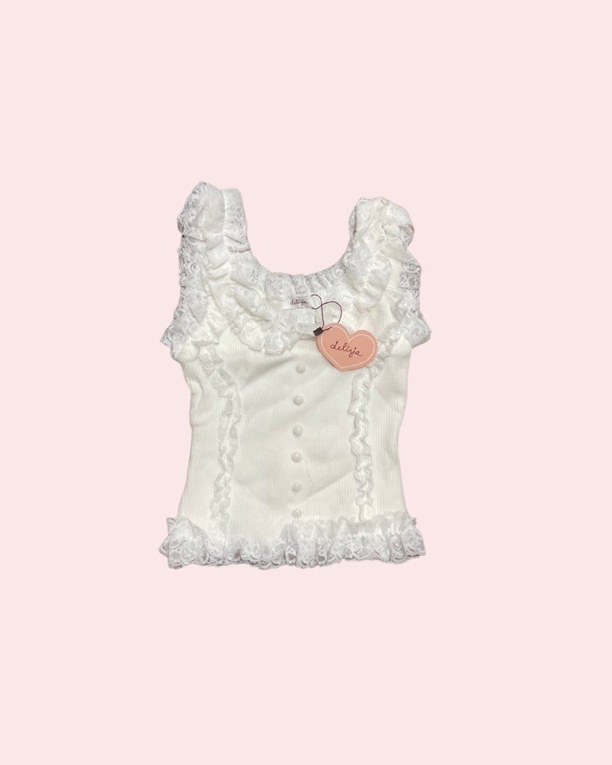 Delizia White Lace Top (Category: Sleeveless) located in Manila. Submitted by mia67 (Listing ID 1415560620, Image 1). Description: - Delizia white top - Lace detailing - Ribbed texture - Button-down front - Delicate lace trim - Heart-shaped tag - Feminine and elegant.