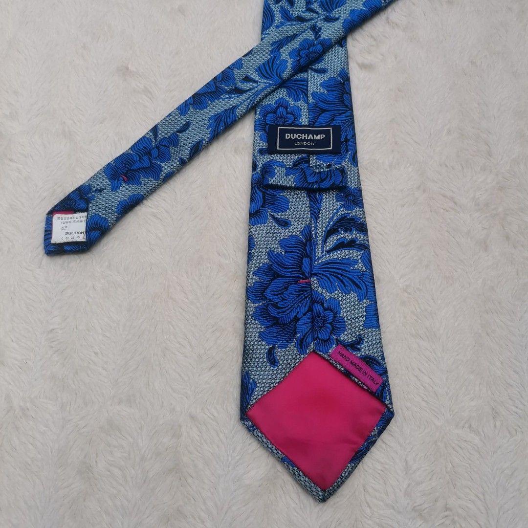 Duchamp London Floral Tie (Category: Ties) located in Manila. Submitted by titojay (Listing ID 1415457443, Image 1). Description: - Duchamp London tie - Blue floral pattern on light blue background - Pink lining - Made in Italy - Intricate design - Adds sophistication.