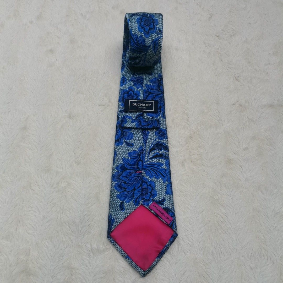 Duchamp London Floral Tie (Category: Ties) located in Manila. Submitted by titojay (Listing ID 1415457443, Image 2). Description: - Duchamp London tie - Blue floral pattern on light blue background - Pink lining - Made in Italy - Intricate design - Adds sophistication.