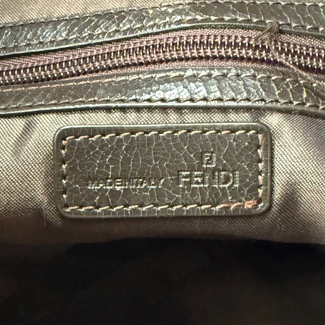 Fendi FF Logo Shoulder Bag (Category: Luxury Bags & Wallets) located in Kabacan. Submitted by rags2penny.phl (Listing ID 1415486450, Image 2). Description: - Fendi shoulder bag - Iconic FF logo pattern - Adjustable brown strap - Top zipper closure - Silver-toned hardware - Interior leather tag with Fendi logo and "Made in Italy" issue : chips on leather (see 5th - 7th photo).