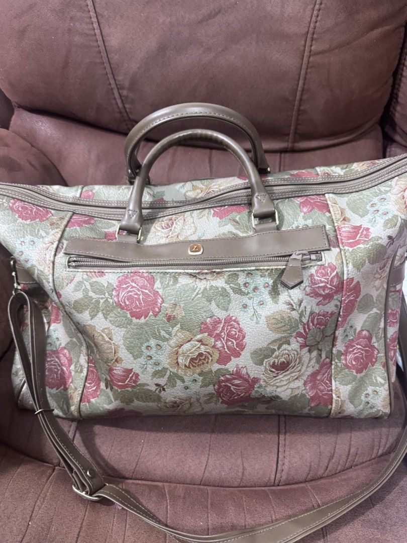Floral Print Tote Bag with Shoulder Strap (Category: Tote Bags) located in Manila. Submitted by marisella (Listing ID 1415577470, Image 2). Description: Tote bag features a beautiful floral print with a combination of pink, green, and beige colors. It has a top handle and a detachable shoulder strap for versatile carrying options. The bag includes a zippered main compartment and a front zippered pocket. The bag has a brown leather trim and handle