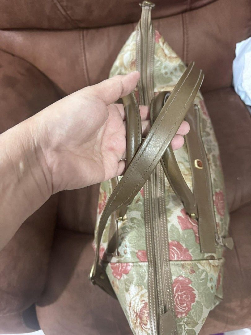 Floral Print Tote Bag with Shoulder Strap (Category: Tote Bags) located in Manila. Submitted by marisella (Listing ID 1415577470, Image 3). Description: Tote bag features a beautiful floral print with a combination of pink, green, and beige colors. It has a top handle and a detachable shoulder strap for versatile carrying options. The bag includes a zippered main compartment and a front zippered pocket. The bag has a brown leather trim and handle
