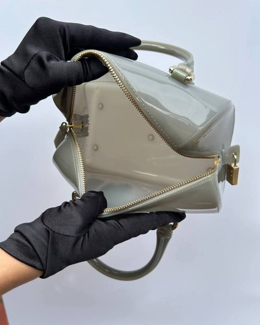 Furla Candy Mini Satchel Bag (Category: Luxury Bags & Wallets) located in Quezon City. Submitted by cornelle_luxuryph (Listing ID 1415592839, Image 2). Description: - Furla Candy Mini Satchel Bag - Glossy grey finish - Top zip closure - Gold-tone hardware - Dual top handles - Compact size - Includes padlock detail.