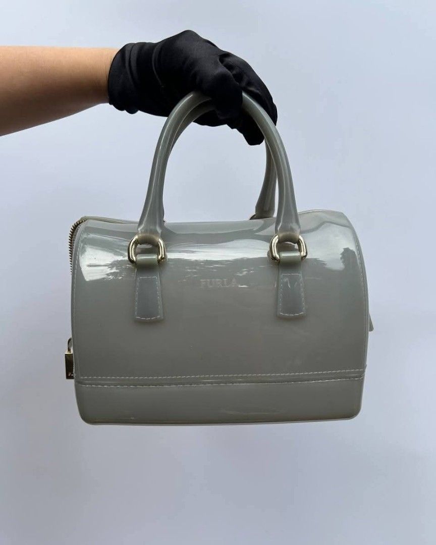 Furla Candy Mini Satchel Bag (Category: Luxury Bags & Wallets) located in Quezon City. Submitted by cornelle_luxuryph (Listing ID 1415592839, Image 1). Description: - Furla Candy Mini Satchel Bag - Glossy grey finish - Top zip closure - Gold-tone hardware - Dual top handles - Compact size - Includes padlock detail.