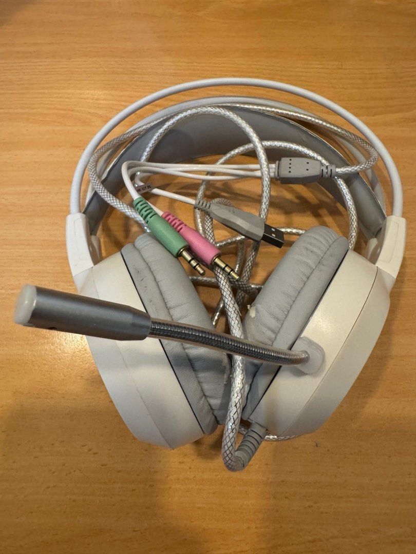Gaming Headset with Microphone (Category: Headphones & Headsets) located in Quezon City. Submitted by things.matter (Listing ID 1415448985, Image 3). Description: Gaming headset with a built-in microphone. It has a white and gray color scheme. The headset has a USB connector and two 3.5mm audio jacks. The earcups are padded for comfort. The microphone is flexible and can be adjusted..