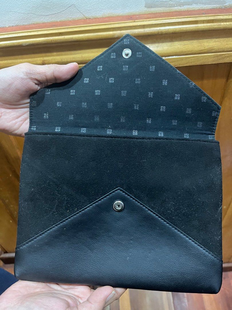 Givenchy Black Envelope Pouch (Category: Luxury Bags & Wallets) located in Davao. Submitted by ammie_digi (Listing ID 1415555939, Image 3). Description: - Black clutch - Authentic - Flap closure - Interior with repeating logo pattern - Snap closure - Made with leather and suede materials.