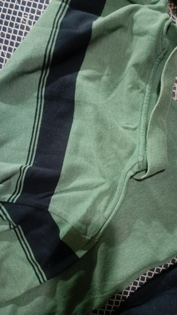 Green Polo Shirt with Navy Stripes (Category: Tshirts & Polo Shirts ) located in General Trias. Submitted by ecsandt (Listing ID 1415520033, Image 3). Description: + Green polo shirt + Black stripes on chest and sleeves + Collared neckline + Button-down placket + Short sleeves + Textured fabric.