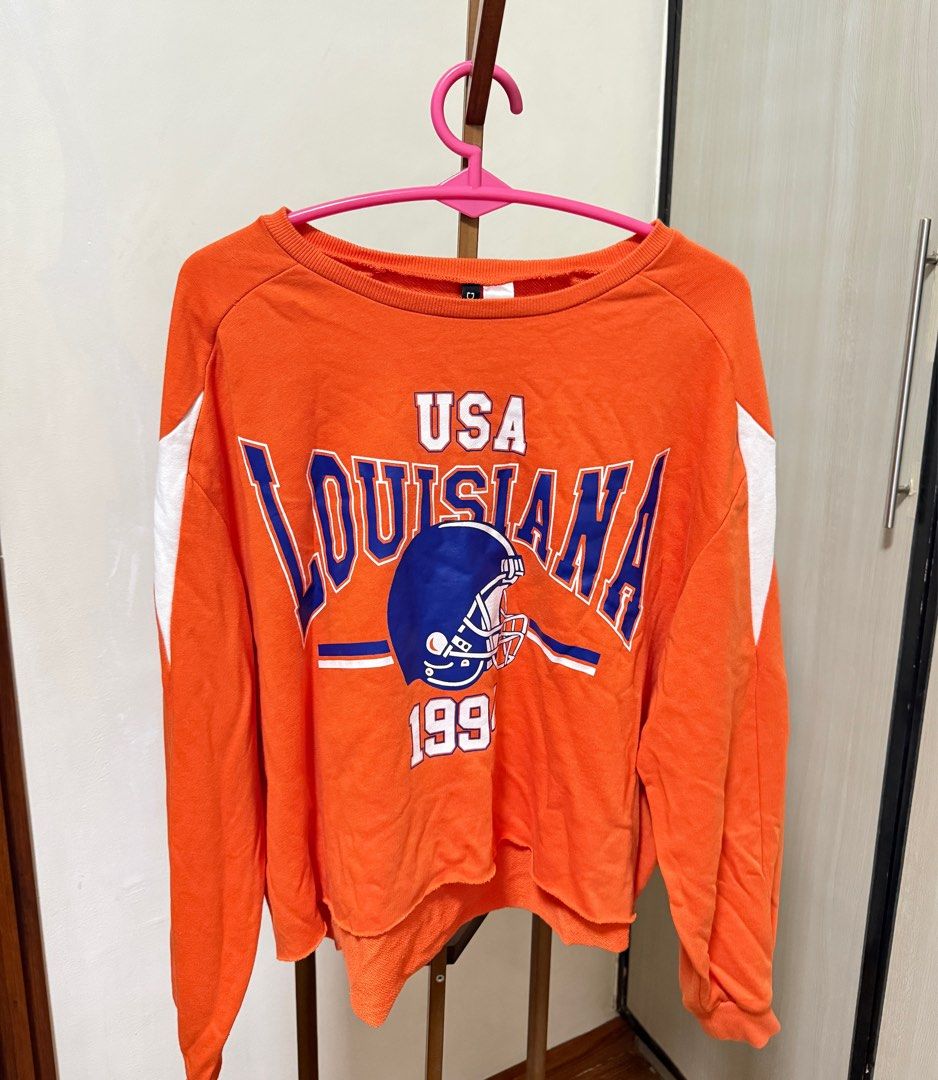 H&M Divided Louisiana Sweatshirt (Category: Longsleeves) located in Manila. Submitted by preluvsbyzee (Listing ID 1415603282, Image 1). Description: - H&M Divided orange sweatshirt - Size: L - Crew neck - Long sleeves .