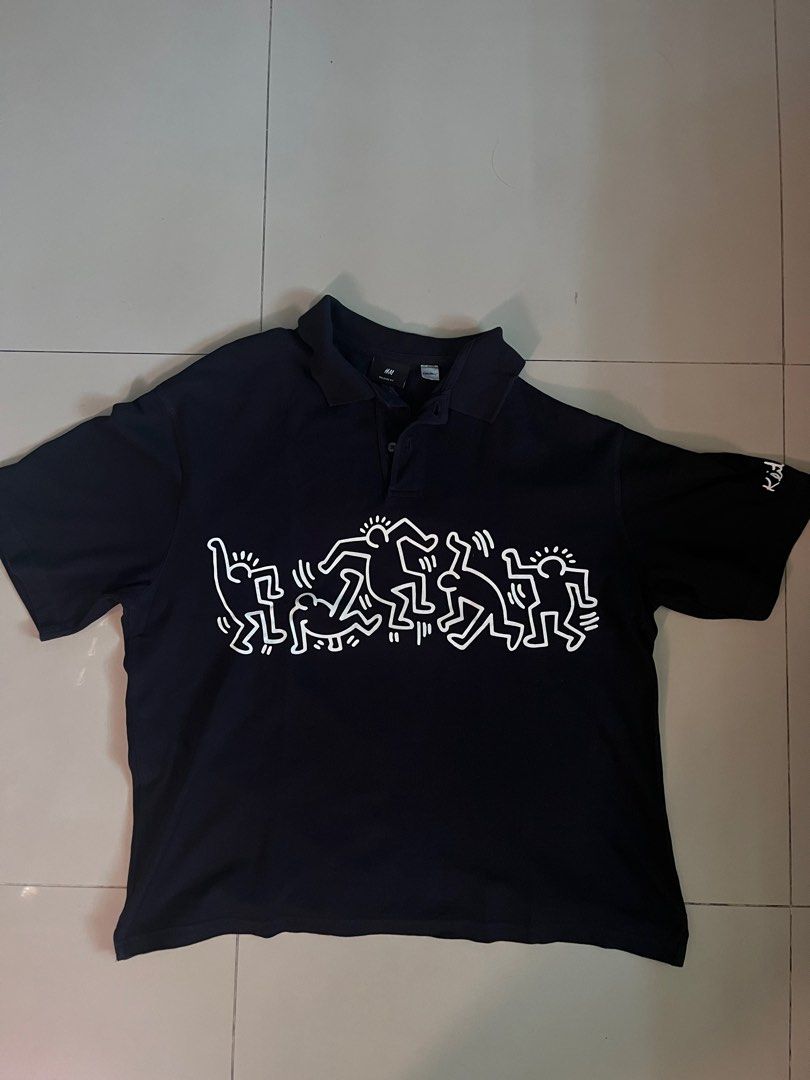H&M Keith Haring Polo Shirt (Category: Tshirts & Polo Shirts ) located in Caloocan City. Submitted by zealturtle-82158b (Listing ID 1415499917, Image 1). Description: - Black H&M polo shirt - Features a Keith Haring design on the chest - Design: White outline of dancing figures - Collared neckline - Short sleeves - Regular fit.