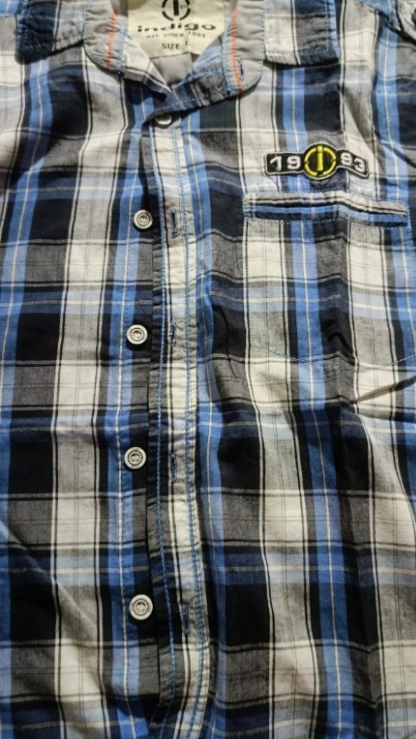 Indigo Plaid Shirt - Size L (Category: Tshirts & Polo Shirts ) located in General Trias. Submitted by ecsandt (Listing ID 1415496542, Image 1). Description: + Indigo polo + Size: L + Button-down closure + Features: Chest pocket, sleeve patch + Color: Blue, black, and white plaid + Brand: Indigo (Est. 1993).