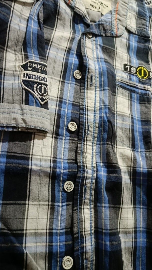 Indigo Plaid Shirt - Size L (Category: Tshirts & Polo Shirts ) located in General Trias. Submitted by ecsandt (Listing ID 1415496542, Image 2). Description: + Indigo polo + Size: L + Button-down closure + Features: Chest pocket, sleeve patch + Color: Blue, black, and white plaid + Brand: Indigo (Est. 1993).