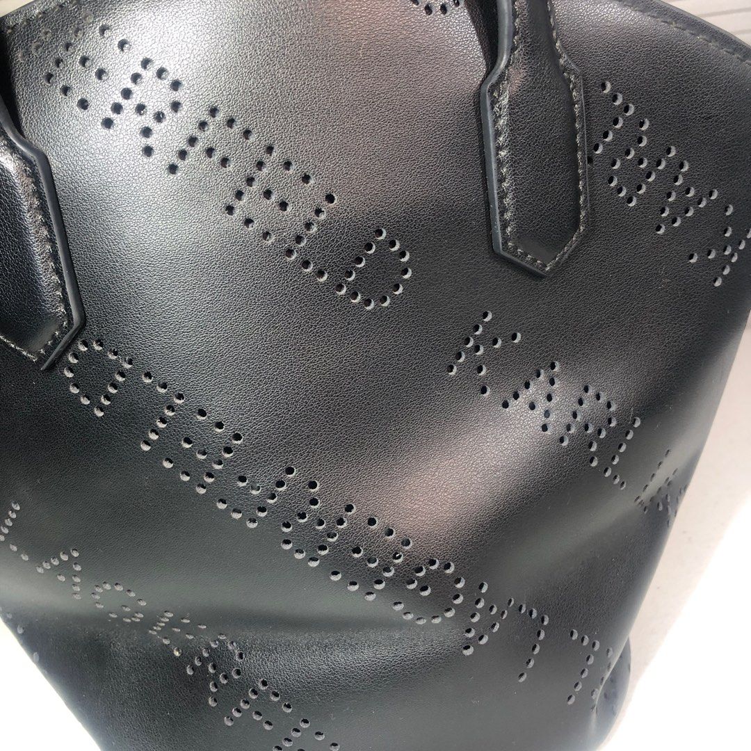 Karl Lagerfeld Perforated Tote Bag (Category: Tote Bags) located in Manila. Submitted by all.dressed.up (Listing ID 1415624208, Image 2). Description: Karl Lagerfeld tote bag Black color Punched logo design Two top handles Interior pocket Black interior with Karl Lagerfeld tag Minor wear on handle Structured shape With signs of usage Missing sling *Manage and limit your expectations when buying used/preloved items. 2,700.