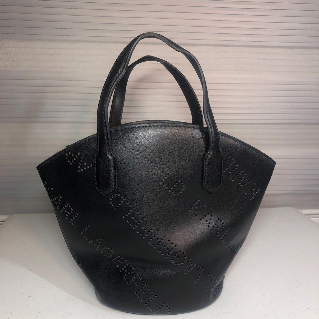 Karl Lagerfeld Perforated Tote Bag (Category: Tote Bags) located in Manila. Submitted by all.dressed.up (Listing ID 1415624208, Image 1). Description: Karl Lagerfeld tote bag Black color Punched logo design Two top handles Interior pocket Black interior with Karl Lagerfeld tag Minor wear on handle Structured shape With signs of usage Missing sling *Manage and limit your expectations when buying used/preloved items. 2,700.