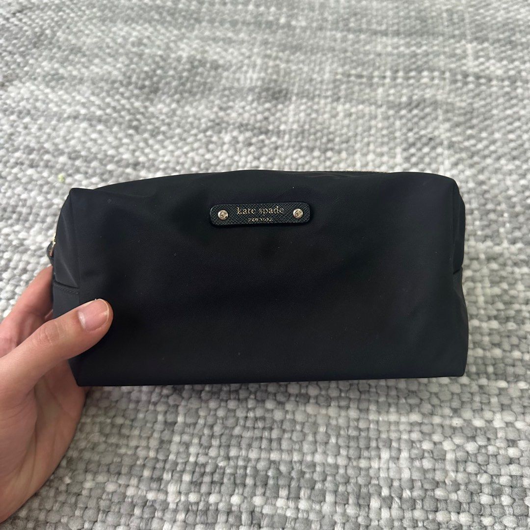 Kate Spade Black Cosmetic Bag (Category: Luxury Bags & Wallets) located in Marilao. Submitted by extra_stuff (Listing ID 1415484873, Image 1). Description: - Black Kate Spade cosmetic bag - Gold zipper detail - Small Kate Spade logo - Interior pocket - Rectangular shape - Made of durable nylon.