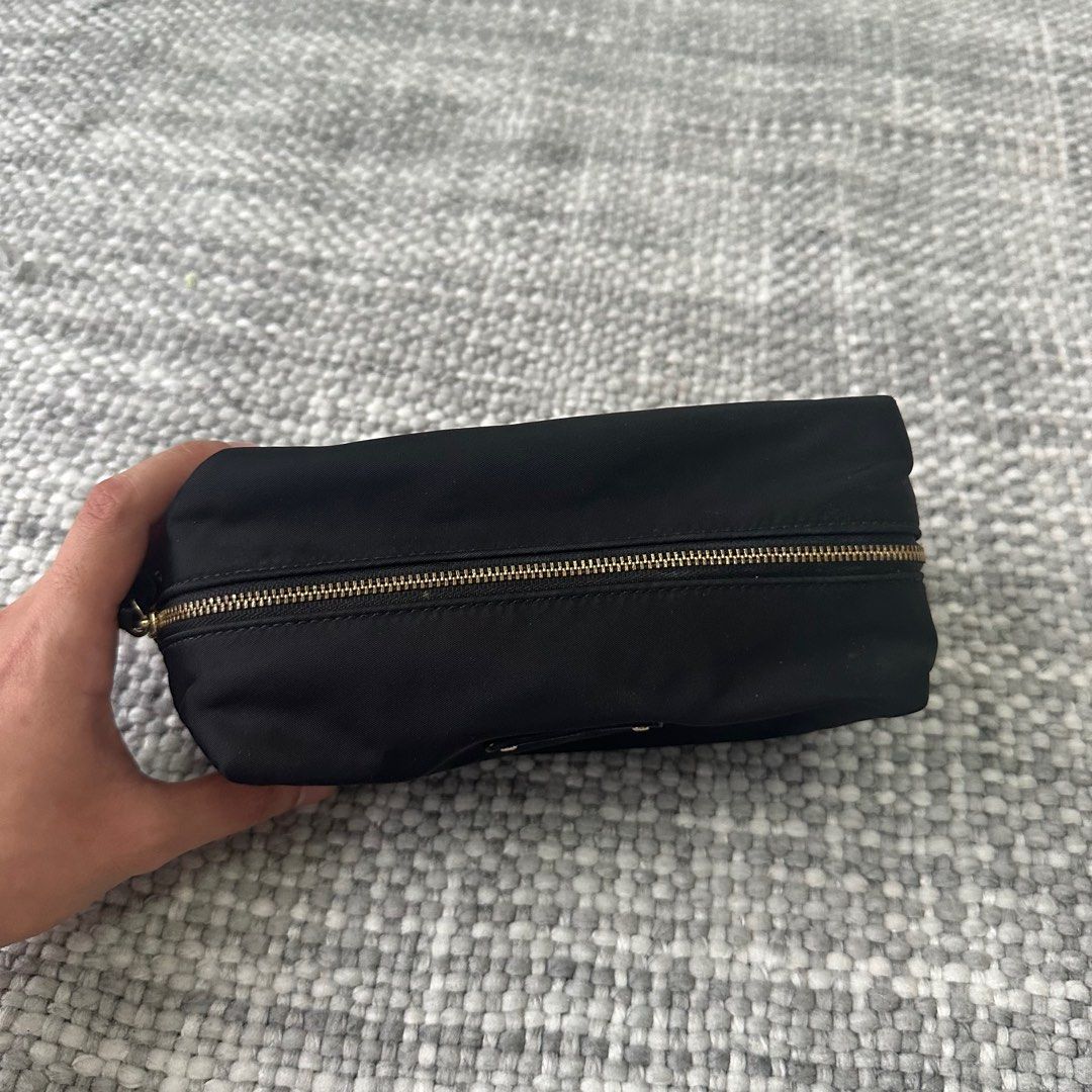 Kate Spade Black Cosmetic Bag (Category: Luxury Bags & Wallets) located in Marilao. Submitted by extra_stuff (Listing ID 1415484873, Image 2). Description: - Black Kate Spade cosmetic bag - Gold zipper detail - Small Kate Spade logo - Interior pocket - Rectangular shape - Made of durable nylon.