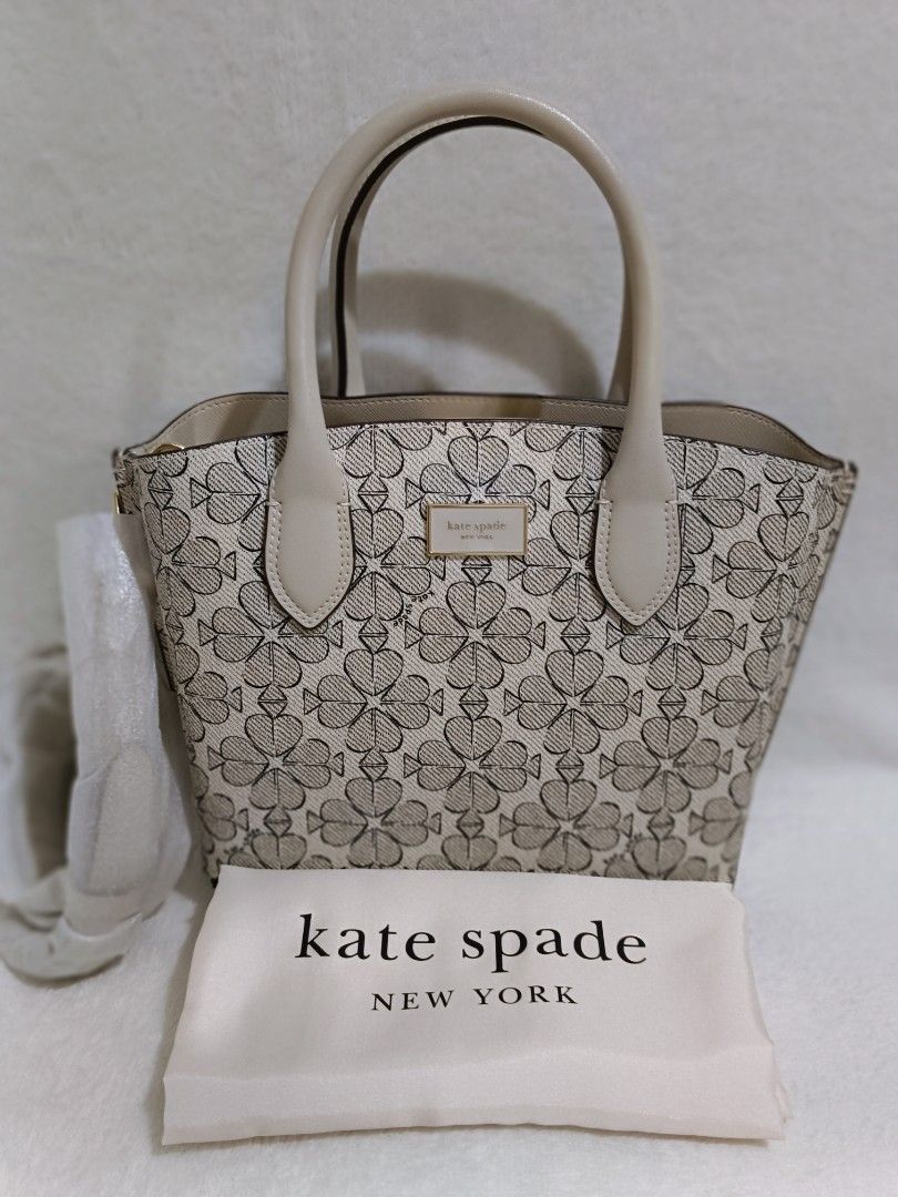 Kate Spade Spade Flower Jacquard Small Tote (Category: Luxury Bags & Wallets) located in Quezon City. Submitted by shinereign (Listing ID 1415525486, Image 2). Description: - Kate Spade tote bag - Spade flower jacquard pattern - Includes dust bag - Top handles - Interior: zippered pocket and small pouch - Neutral color palette - Light beige interior - Small to medium size - Ideal for everyday use.