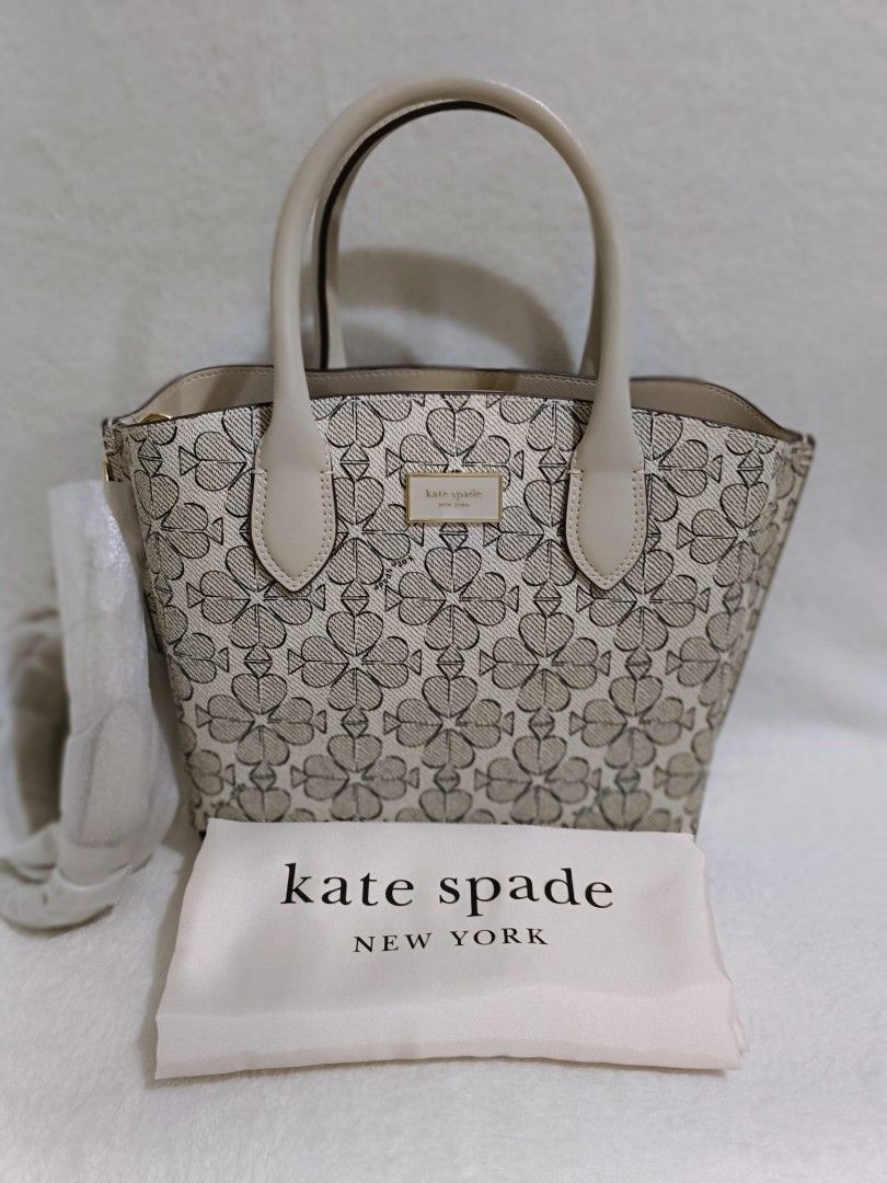 Kate Spade Spade Flower Jacquard Small Tote (Category: Luxury Bags & Wallets) located in Quezon City. Submitted by shinereign (Listing ID 1415525486, Image 1). Description: - Kate Spade tote bag - Spade flower jacquard pattern - Includes dust bag - Top handles - Interior: zippered pocket and small pouch - Neutral color palette - Light beige interior - Small to medium size - Ideal for everyday use.