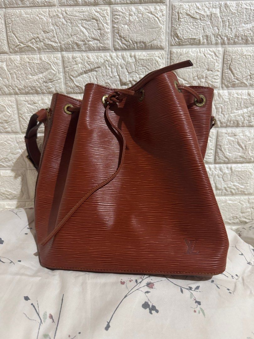 Louis Vuitton Epi Leather Bucket Bag (Category: Luxury Bags & Wallets) located in Manila. Submitted by sheenahay (Listing ID 1415601050, Image 1). Description: - Authentic Louis Vuitton Bucket Bag - Epi Leather in Brown - Drawstring closure - Shoulder strap - Textured Epi leather exterior - LV logo detail - Signs of wear present With entrupy cert No other inclusions Payment: bank deposit or gcash.