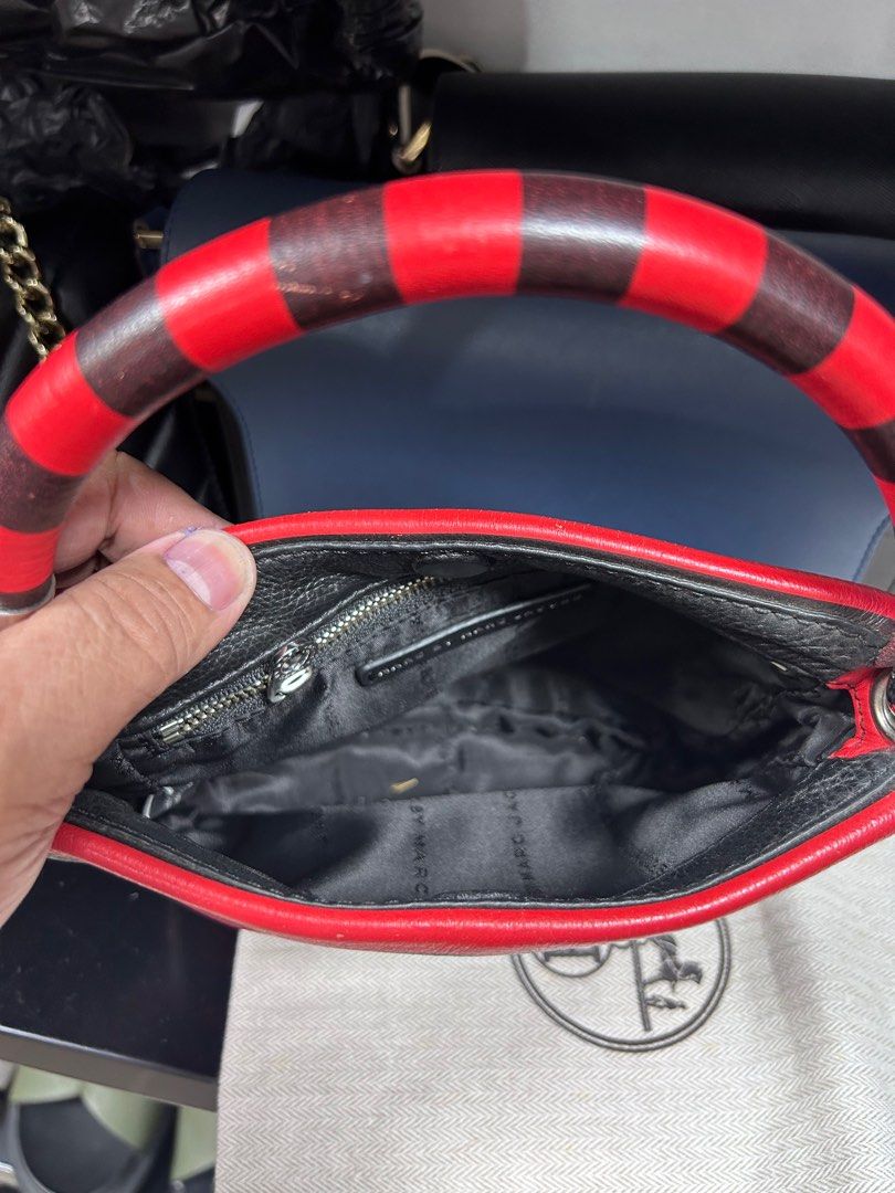 Marc by Marc Jacobs Striped Handbag (Category: Luxury Bags & Wallets) located in Pateros City. Submitted by blitzkriegspc (Listing ID 1415493275, Image 3). Description: - Marc by Marc Jacobs handbag - Striking red and black striped design - Top handle with matching stripes - Black interior with zippered pocket - Rectangular shape - Silver-toned hardware - Brand name visible on front and inside.