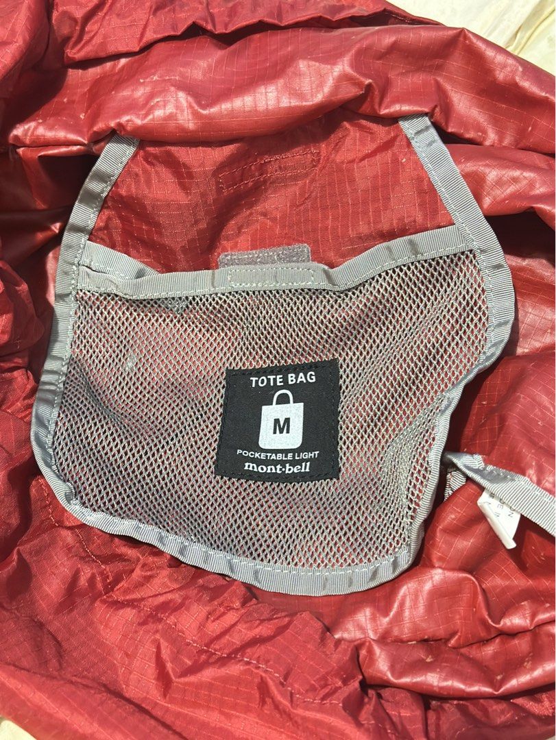 Mont-Bell Tote bag Pocketable Light (Category: Backpacks) located in General Santos City (Dadiangas). Submitted by toysville888 (Listing ID 1415490003, Image 3). Description: This is a red Mont-bell packable tote bag made from water-resistant nylon material. It features: An ultra-lightweight design that folds into a compact size. A spacious main compartment with drawstring closure. mesh side pocket for water bottles or other items. A front zipper