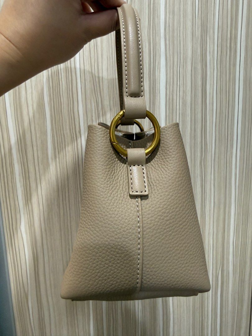 Mr. Leather Soft Cowhide Handbag (Category: Tote Bags) located in Pasig City. Submitted by abbyrds (Listing ID 1415518411, Image 2). Description: - Mr. Leather mini bucket bag - Color: Apricot - Material: Textured cowhide leather - Features: - Top handle - Detachable strap - Main compartment - Interior pockets - Dimensions: Approximately 19cm (length) x 14cm (height) x 11cm (width) - brand new, unused bought for 3k+ selling for 1900 only.