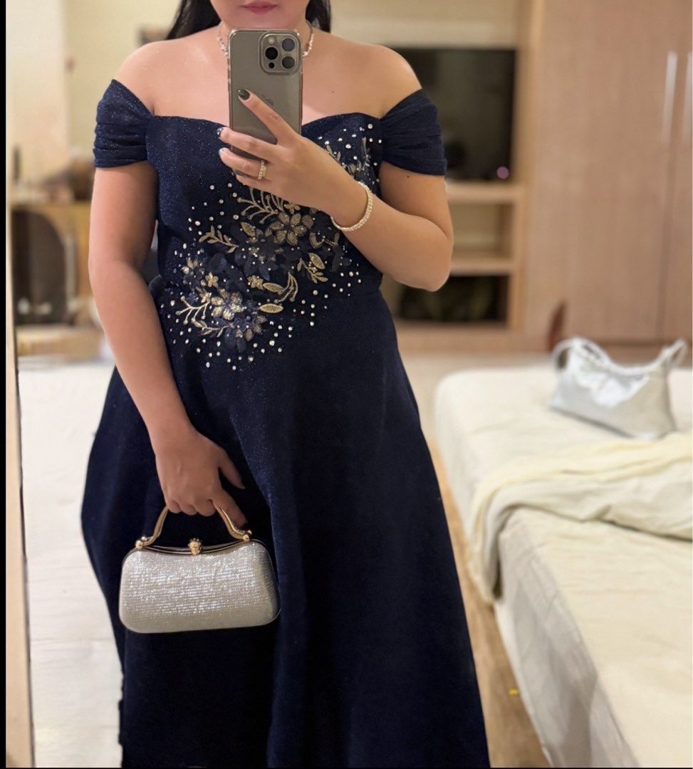 Navy Blue Off-Shoulder Dress (Category: Dresses) located in Quezon City. Submitted by decluttering.mommah (Listing ID 1415613239, Image 1). Description: Navy blue off-shoulder dress with floral bodice detail. Mid-calf length, perfect for formal events. Flattering silhouette. Fits up to 32 waistline.